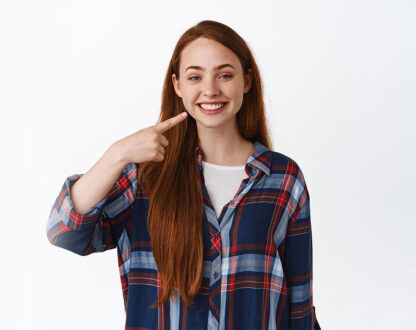 Girl showing her beautiful smile after getting dental crowns in Markham.
