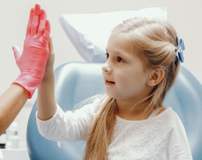Little girl with dentist in Markham at New Delhi Dental.